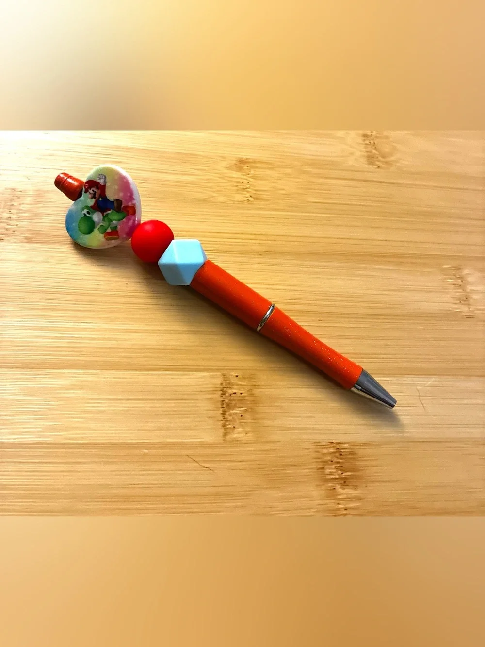 Character Themed Orange Beaded Pen with Blue and Red Accents
